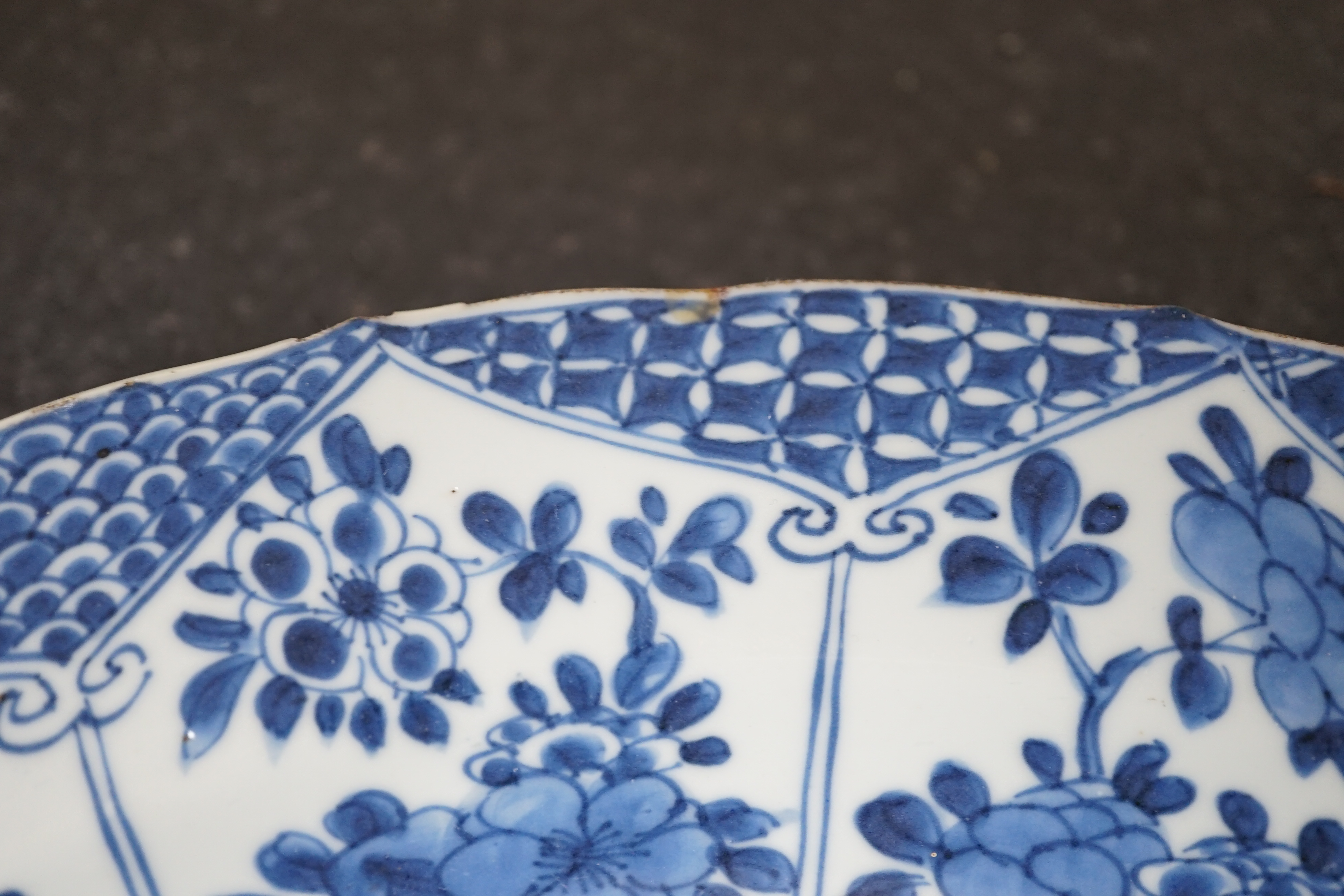 A pair of Chinese blue and white ‘garden’ dishes, Kangxi period, fritting and glaze chips